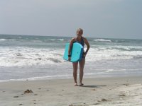 Kayla walking on beach with boogie board at Carlsbad 7-29-05