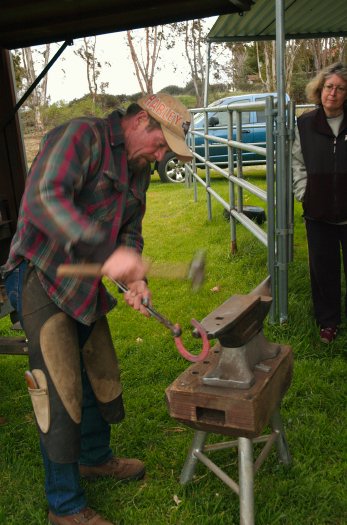 Blacksmith shaping horseshoe at Schuremans in Cameron Park 12-27-04